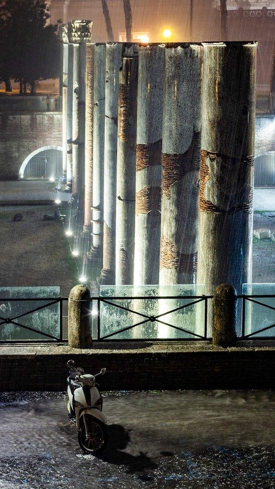 Water floods the Trajan Forum in central Rome