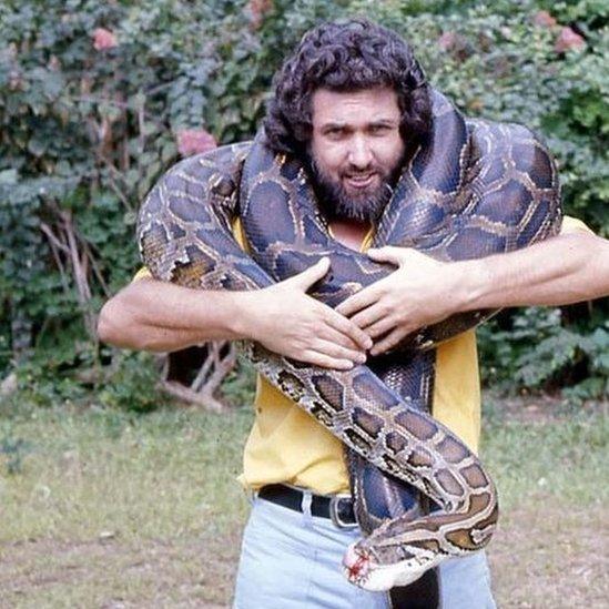 Bob Golding with a Burmese python wrapped around his neck