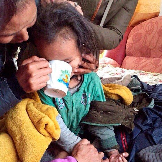 Tserin Dopchut receiving a drink soon after his rescue