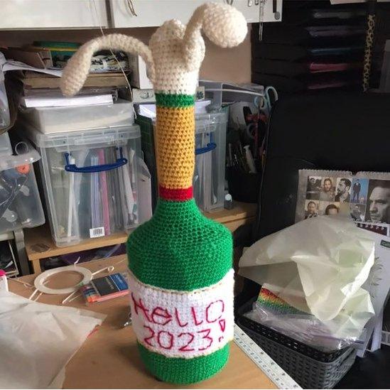 A champagne 'Hello 2023' postbox topper