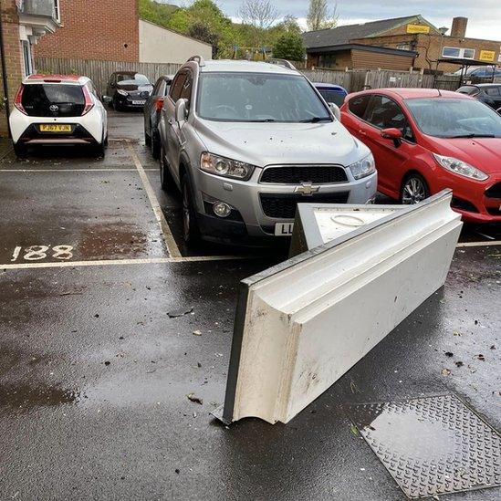 Debris from a nearby property narrowly missed a parked car