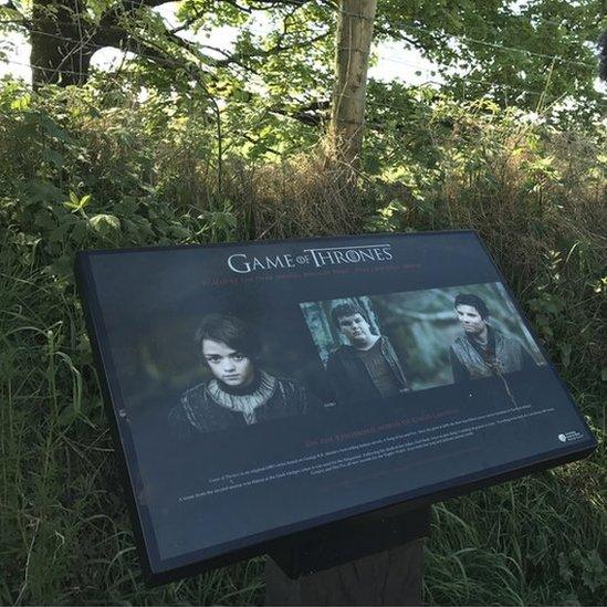 A sign at the Dark Hedges marks the site's contribution to the TV show