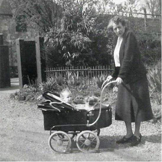 Black and white photo of Ms Brooke with her granddaughter Ann in a pram