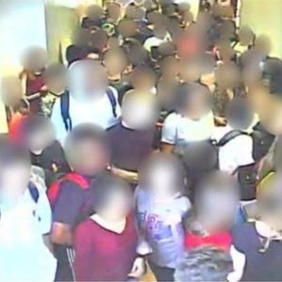 Students seen in corridor with blurred faces