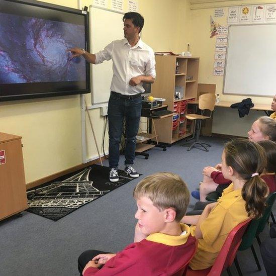 Dr James Geach with pupils