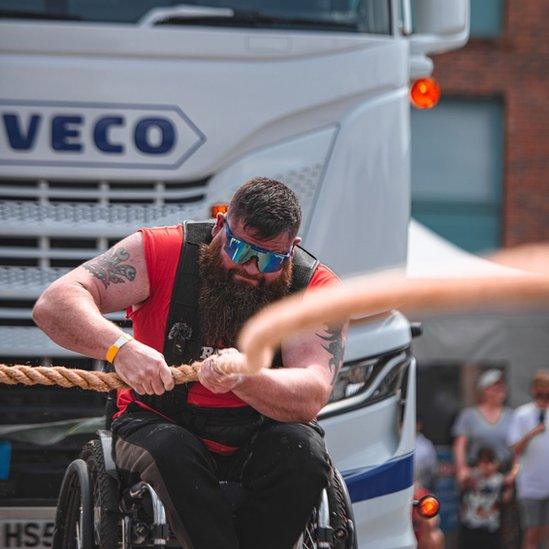 Dave Walsh pulling a lorry with a rope