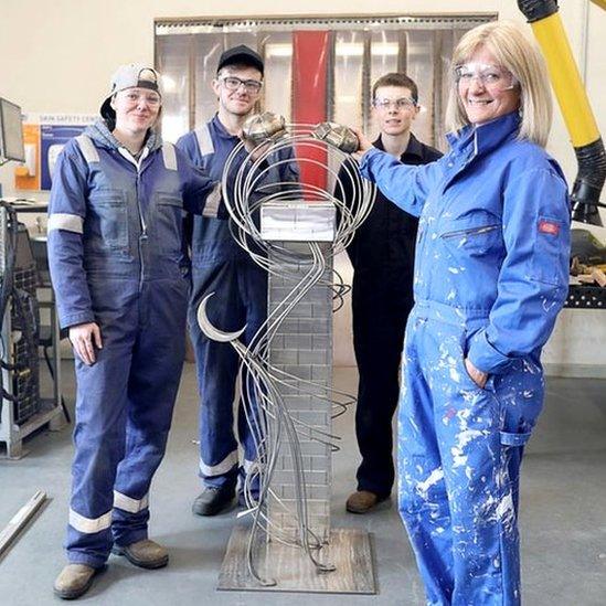 Catriona Tinsley and her sculpture, Puffin Bridge, with some of the Fabrication and Welding students