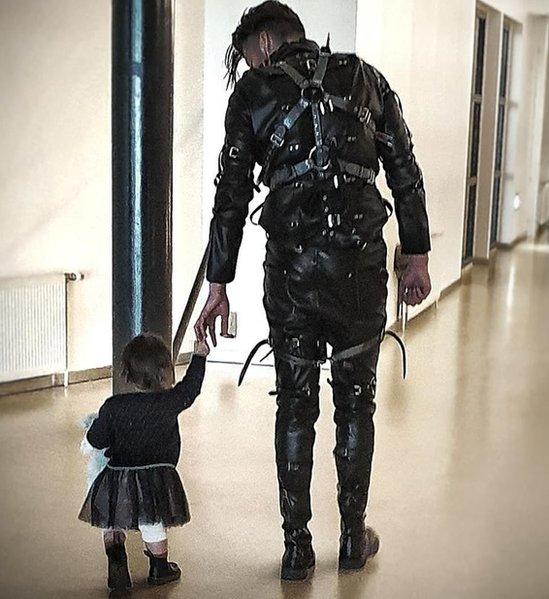 A band member walks with a child after their winning performance in Iceland