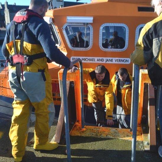 Crew back via lifeboat