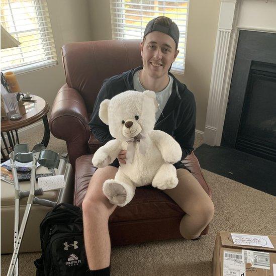 Sean Dougherty posing with a teddy bear