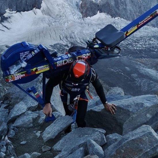 Matthew Disney scales a mountain with a rowing machine