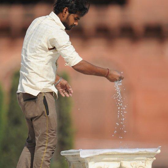 A man cleaning the iconic bench at the Taj Mahal