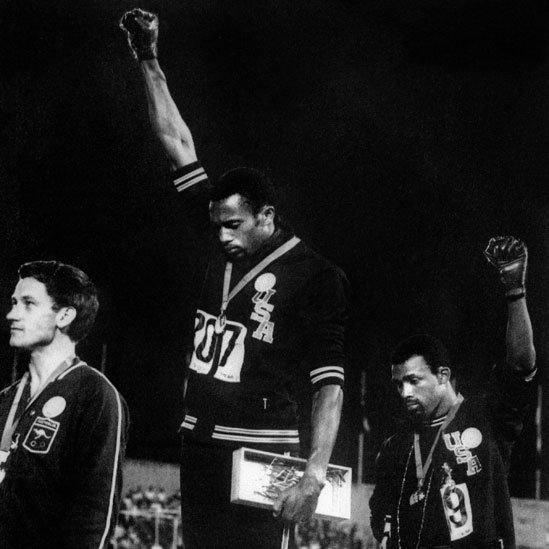 Black American athletes Tommie Smith (centre) and John Carlos