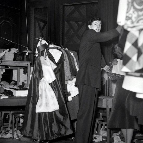 French aristocrat and fashion designer Hubert de Givenchy backstage at 1952 fashion show, in black and white image