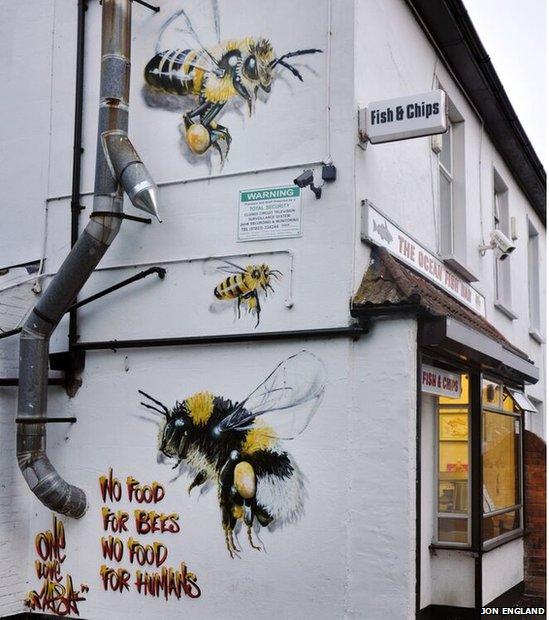 The bees mural on the side of a fish and chip shop. Artist Louis Masai, SAW and Somerset Wildlife Trust - Routes to the River Tone.