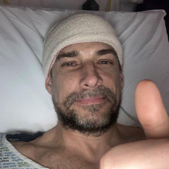 Craig Russell in hospital bed after the operation