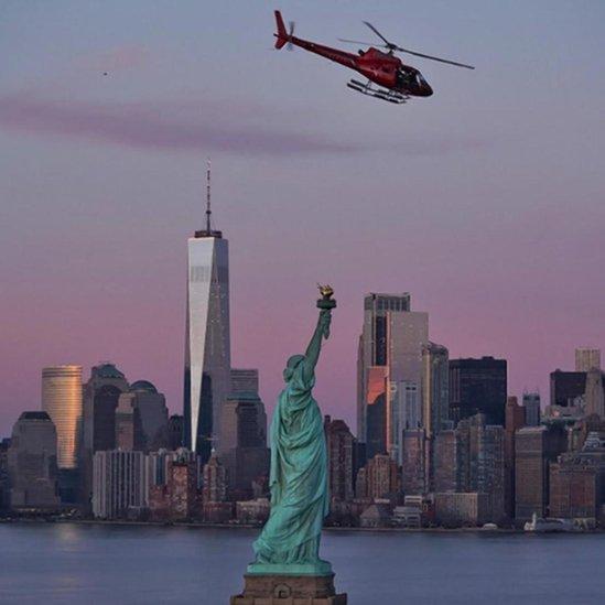 The ill-fated helicopter is seen over the Statue of Liberty