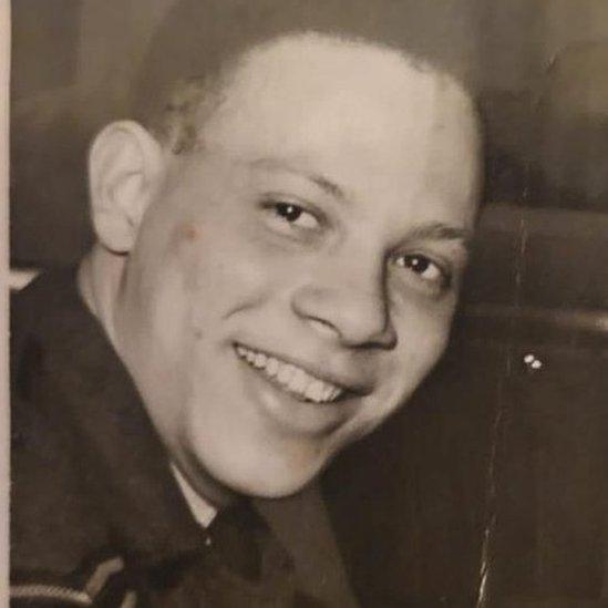 A black and white photo showing a younger Flt Sgt Peter Brown smiling