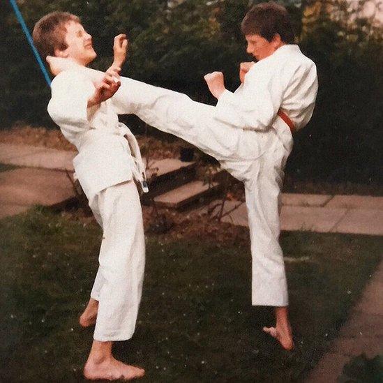 A young Bryan Larkin, right, doing karate