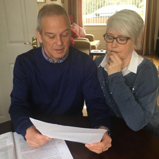 Alan and Jennifer Roberts with the letter from the attorney general