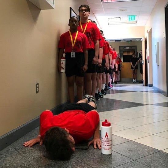 Junior cadet is made to do push-ups after a room inspection