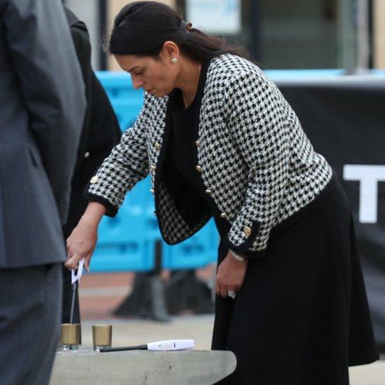 Home Secretary Priti Patel lighting a candle