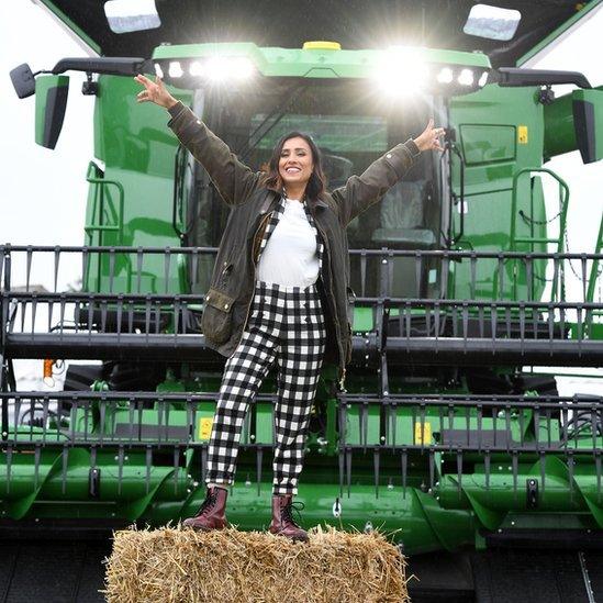 TV presenter Anita Rani with the world's biggest combine harvester