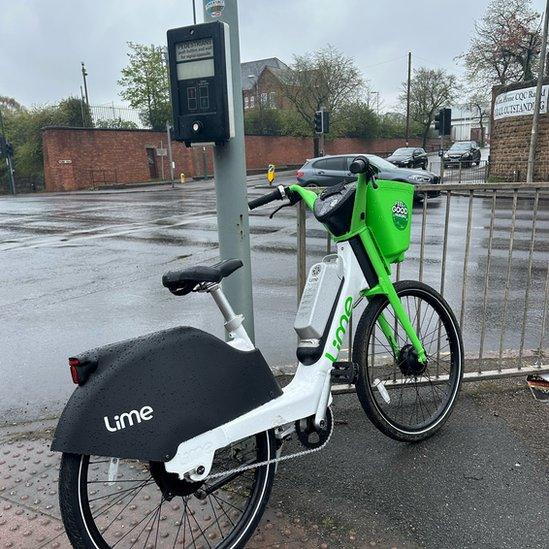 A bike blocking a pedestrian crossing