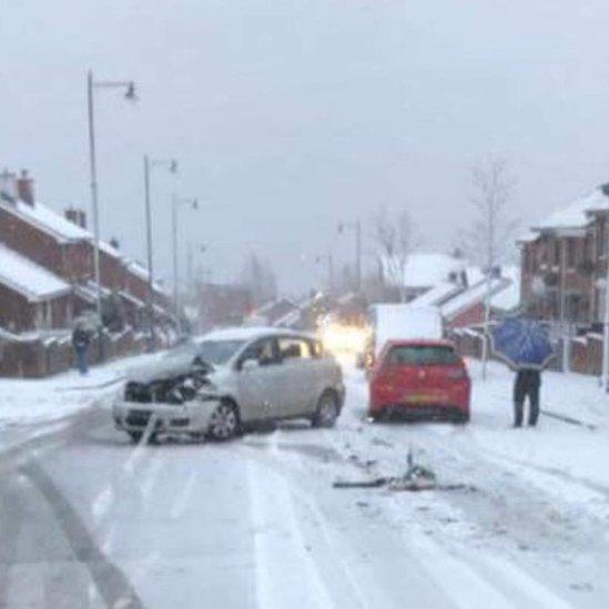 A car crashed in snowy conditions on Belfast's Ligoniel Road