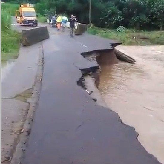 People look at a road damaged due to Dorian in Riviere-Pilote, Martinique