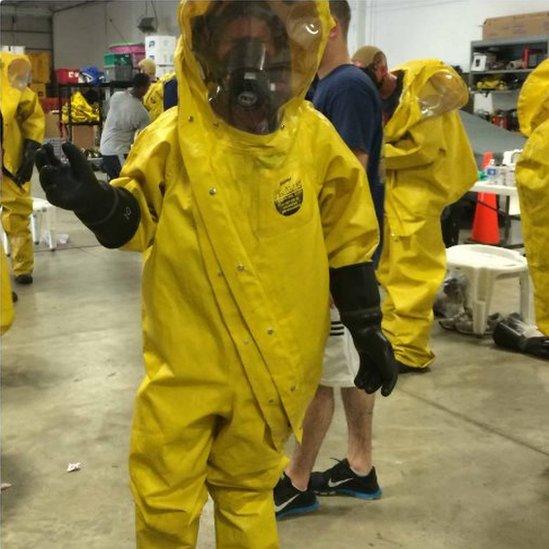 Picture of a woman wearing a Biohazard suit