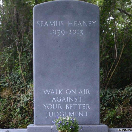 The inscription on the headstone is a line from Seamus Heaney's poem The Gravel Walks