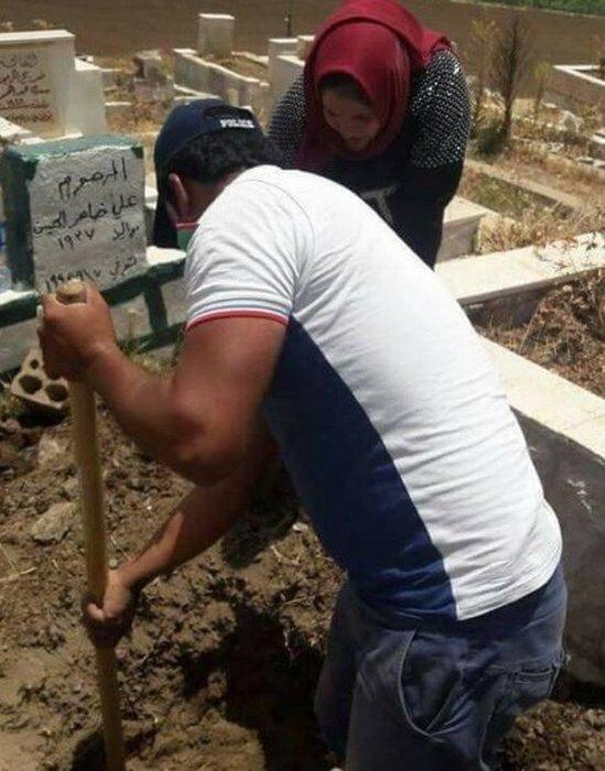 Man helping to dig up grave