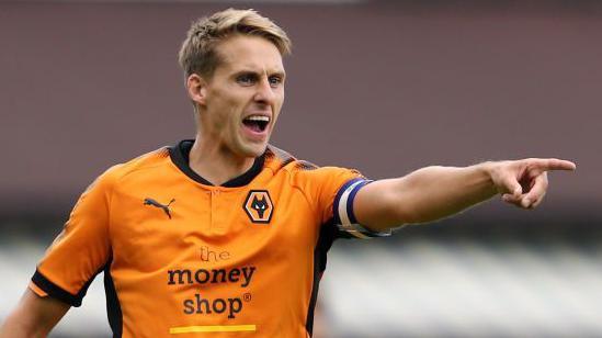 Dave Edwards points and shouts to team-mates during a game for Wolves