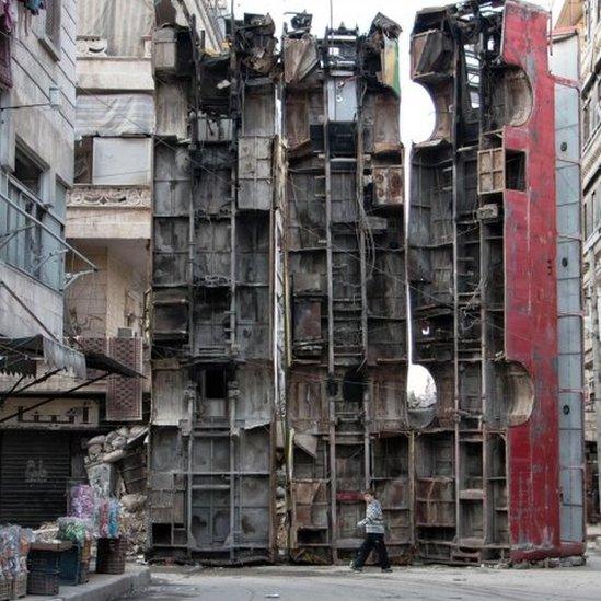 A makeshift barricade of bus wreckage in rebel-held eastern Aleppo .(14 March 2015)