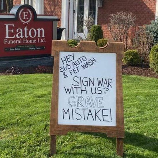 A sign at a funeral home reads 'Sign war with us? Grave mistake'