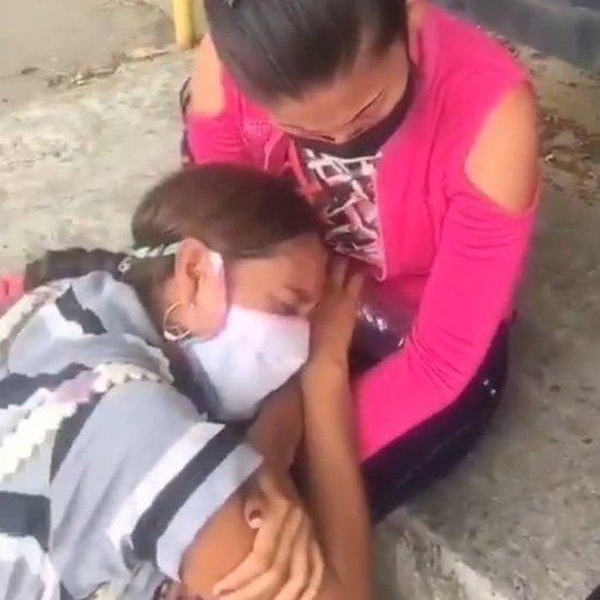 Two women wearing masks cry outside Los Llanos jail in Guanare, Venezuela, 2 May 2020)