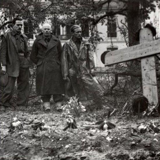 British Soldiers standing respectfully at a grave in Arnhem, 1944