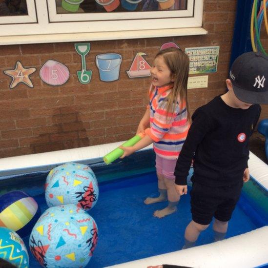 Kids in the paddling pool.