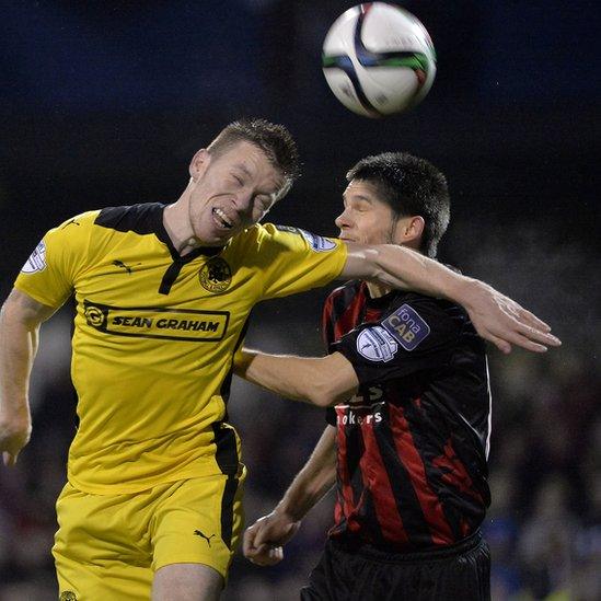 Stephen Garrett of Cliftonville and Crusaders defender Craig McClean compete for a high ball during the clash between the top two teams in the Irish Premiership