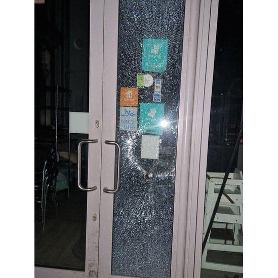 Petit Cafe doors smashed by vandals