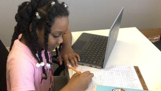 Kellyse Brown, 9, works at her desk