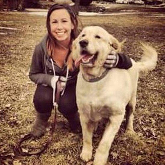 Kat poses with her golden retriever Jacob