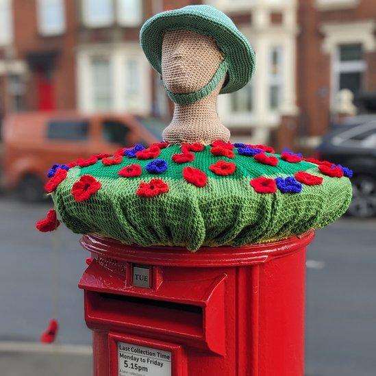 Knitted postbox topper in South Shields