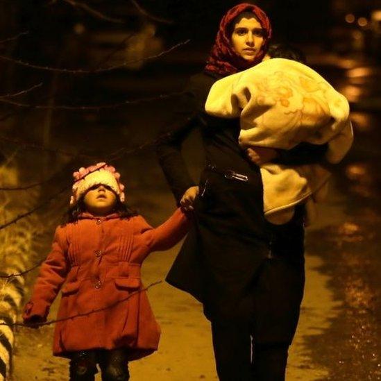 A woman with children walks on the outskirts of the besieged rebel-held Syrian town of Madaya. Photo: 11 January 2016