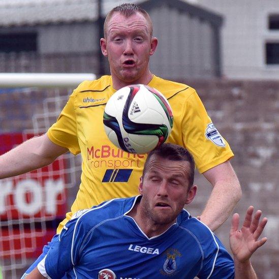 Ballymena defender Kyle McVey competes with Terry Fitzpatrick of Dungannon Swifts