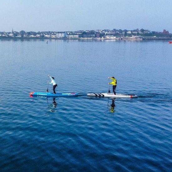 Paddle-boarders off the coast of Bangor