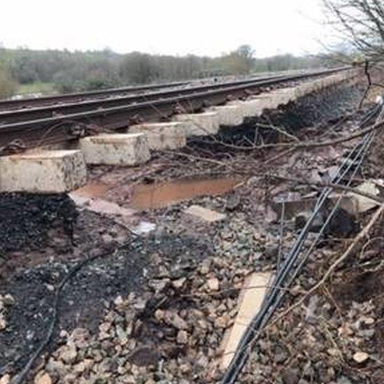 The rail bed has been washed from under rail lines