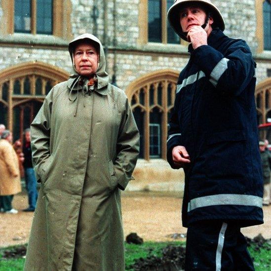 The Queen inspects Windsor Castle with a fireman, the day after the November 1992 blaze