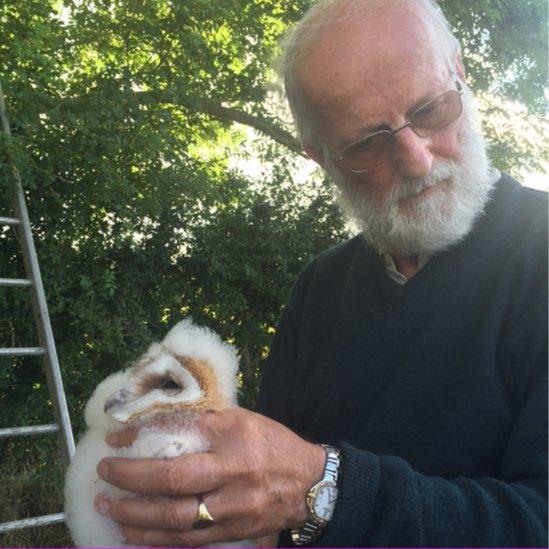 Michael Calvert with barn owl chick